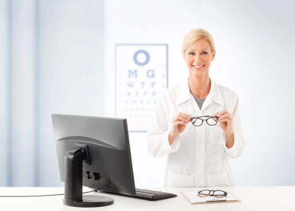 Female doctor giving patient new glasses to try out their updated prescription