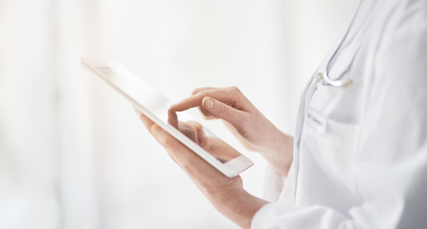 Doctor using an iPad to look at a patient's electronic medical record