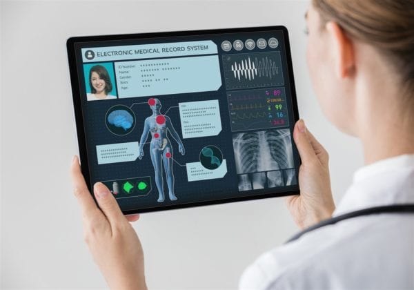 Optometrist looking at a patient's electronic medical record to diagnose the patient's chronic pain