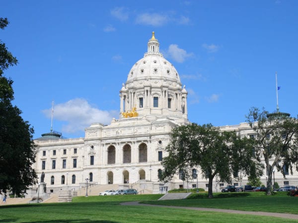 Minnesota State Capitol Building in Saint Paul on a bright sunny day with blue skies and leafy trees