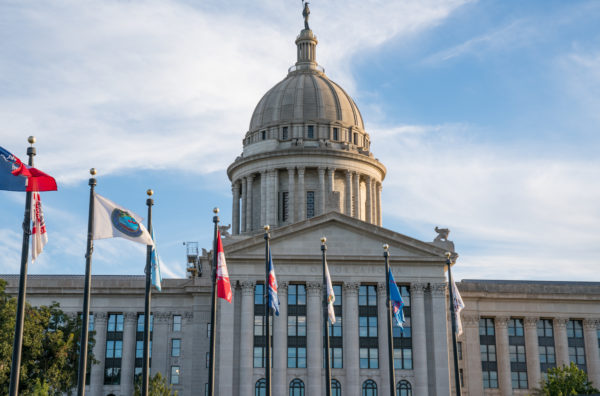 Oklahoma State Capital Building with flags waving in the wind